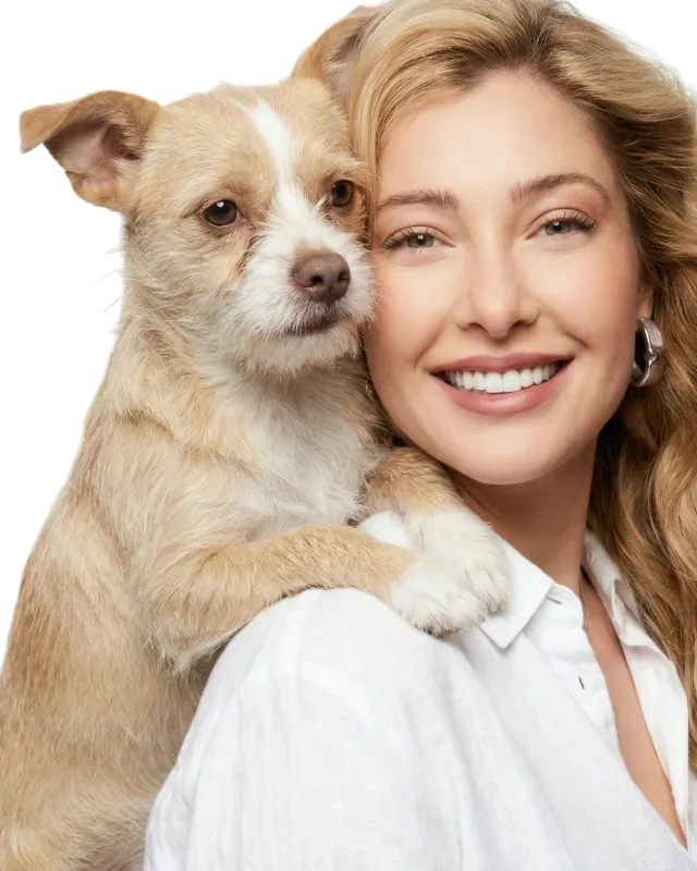 Crystal Schainuck smiling, with her dog resting its paws on her shoulder
