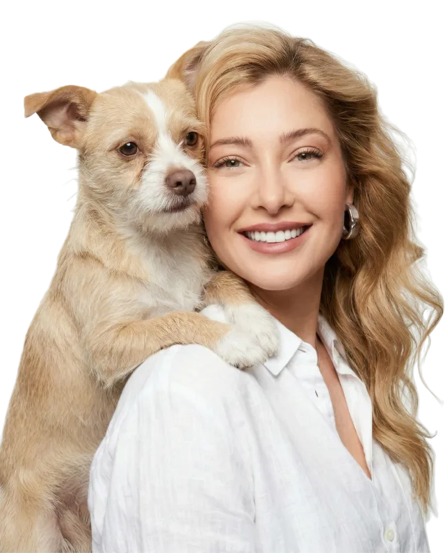 Crystal Schainuck smiling, with her dog resting its paws on her shoulder